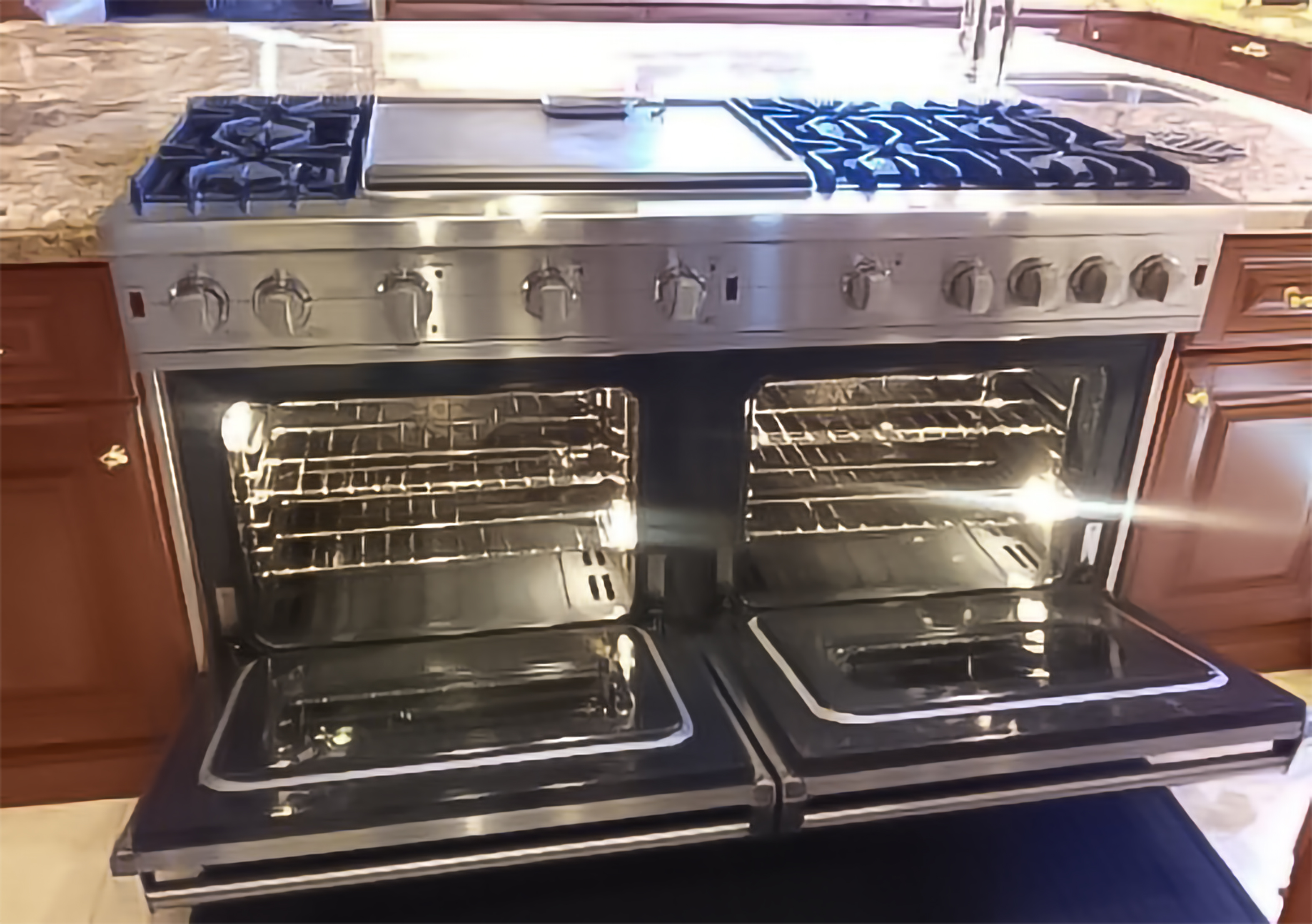 Immaculate professional double oven range — vacation rental cleaning